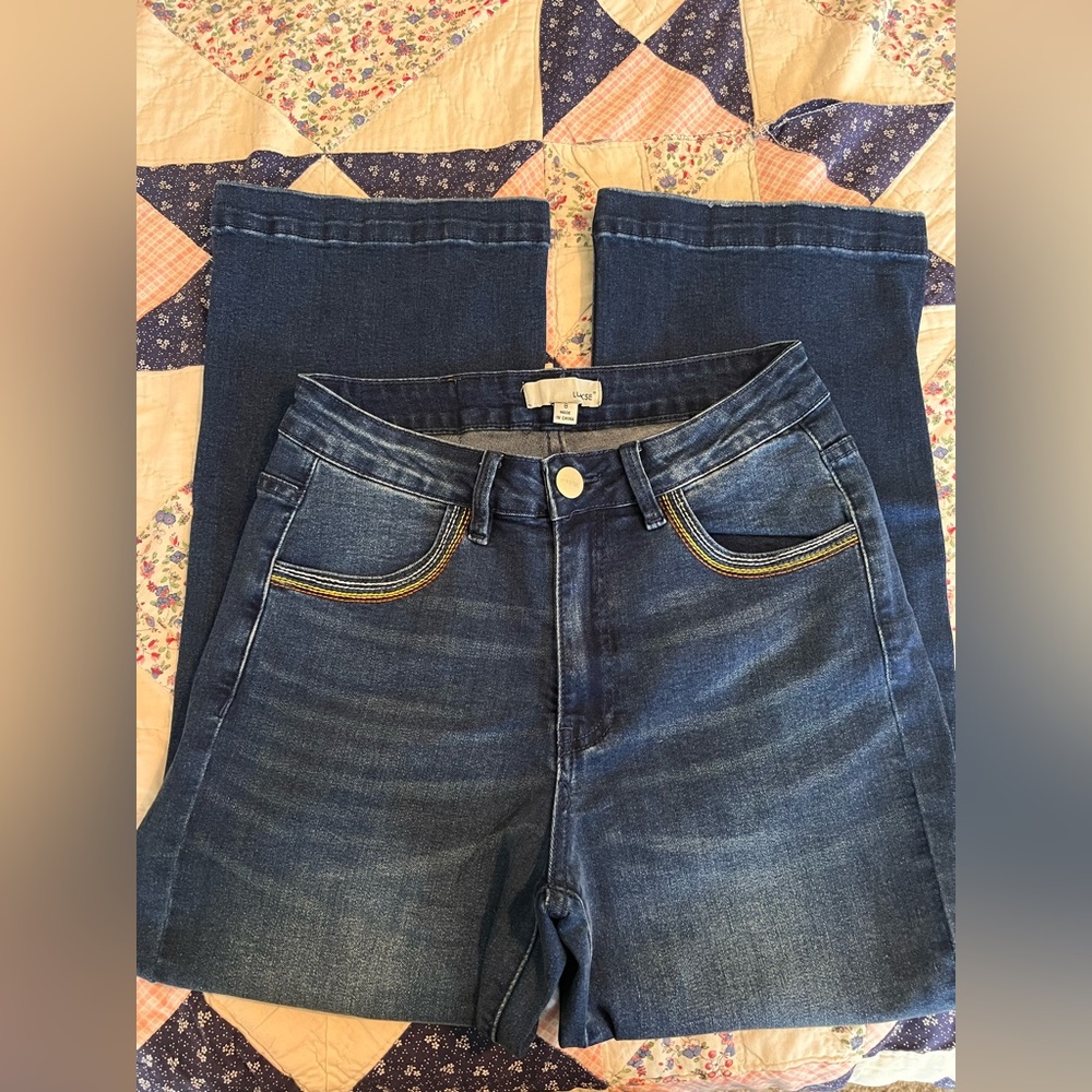 Wide leg crop jeans with rainbow detail pocket.